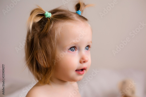 Portrait of a toddler girl playing at home with her parents