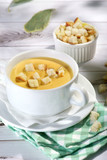 cream cheese soup with crackers on a light background