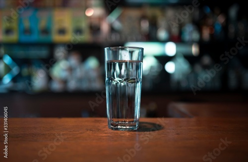 Glass of water placed on wooden table. Close up of glass of water cool ice
