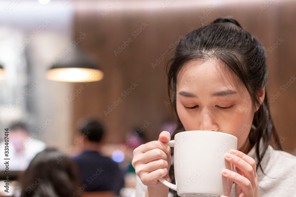 Young beautiful girl holding a cup of coffee in cafe. Outdoor portrait of young beautiful woman posing while traveling holiday vocation. Girl with coffee. Female traveler, travel vacation fun summer. Young beautiful girl holding a cup of coffee in cafe. Outdoor portrait of young beautiful woman posing while traveling holiday vocation. Girl with coffee. Female traveler, travel vacation fun summer.