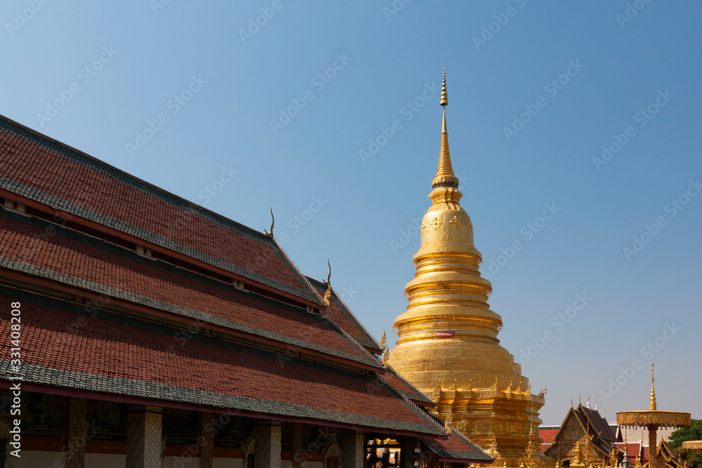 Fototapeta premium Beautiful Golden Pagoda in a Temple in Northern Thailand. Golden Pagoda background at the beautiful temple.