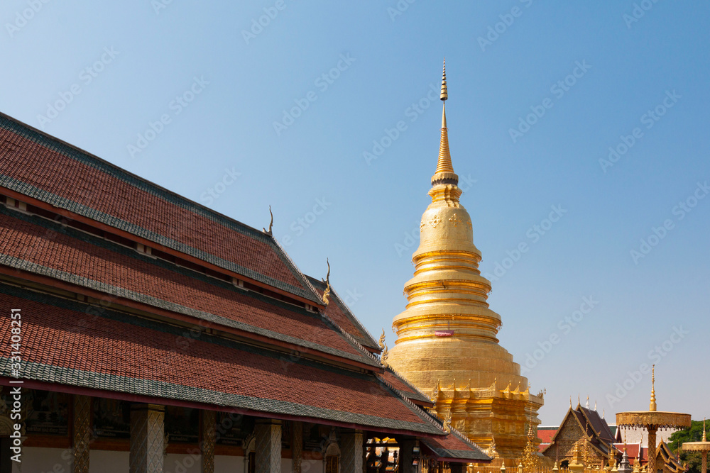 Fototapeta premium Beautiful Golden Pagoda in a Temple in Northern Thailand. Golden Pagoda background at the beautiful temple.