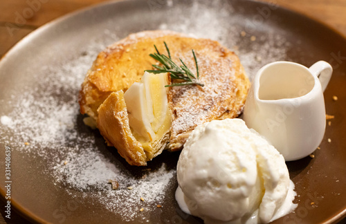 Ice Cream with coconut pie on a rustic plate with syrup. Homemade Vanilla Ice cream together with fresh make coconut pie. Selective focus of Ice Cream serve with Homemade coconut pie.