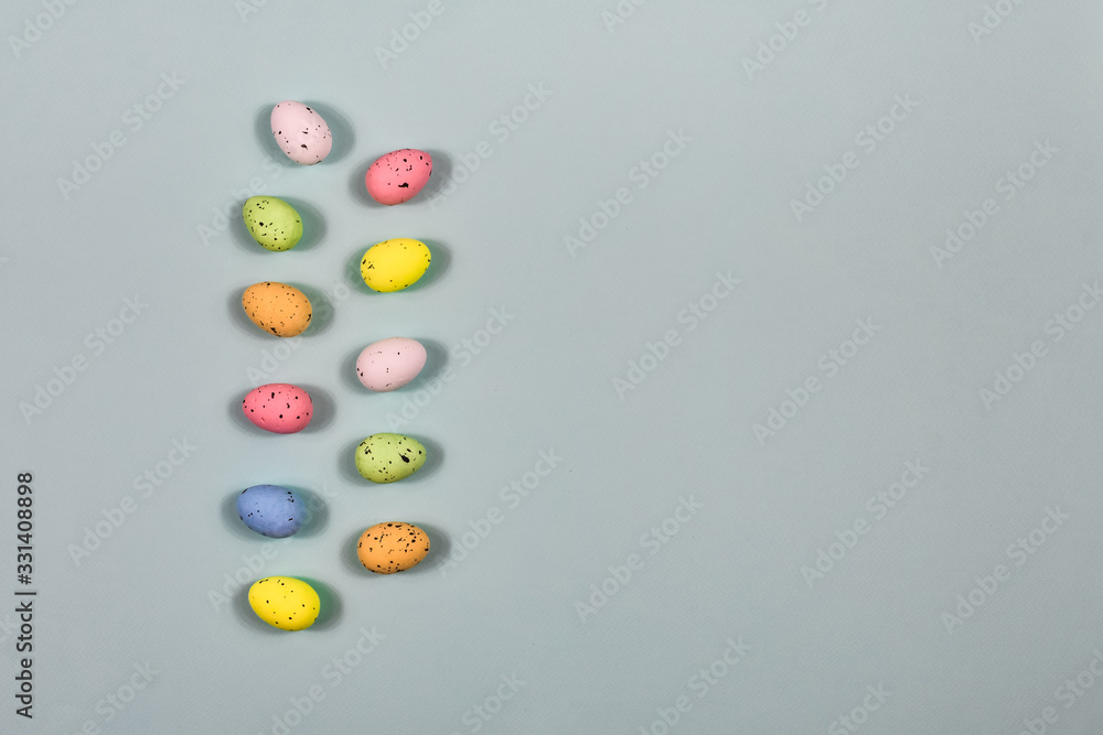 A row of Easter eggs on a yellow background. Easter concept. View from above. Place for an inscription. The basis for the postcard. Close-up. A row of Easter eggs on a yellow background. Easter concept. View from above. Place for an inscription. The basis for the postcard. Close-up.