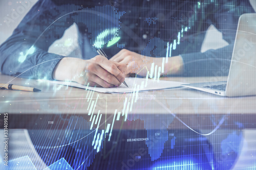 Double exposure hands with stock market chart.