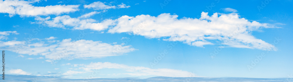 Fototapeta premium Beautiful clouds on a blue sky, wide panorama