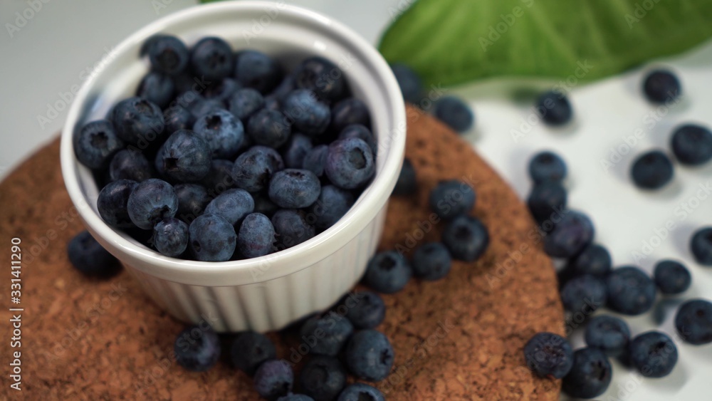 Heap of fresh blueberries in white bowl. Closeup shot. Fresh berry series Heap of fresh blueberries in white bowl. Closeup shot. Fresh berry series