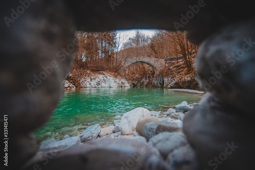 Beautiful stone bridge on Nadige river in enchanted forest photo