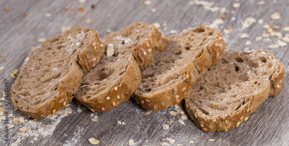 fresh slices of rye bread on wooden surface