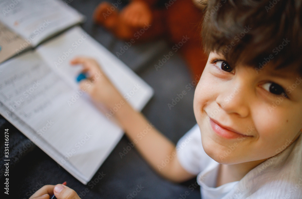 Smiling boy doing homework Smiling boy doing homework