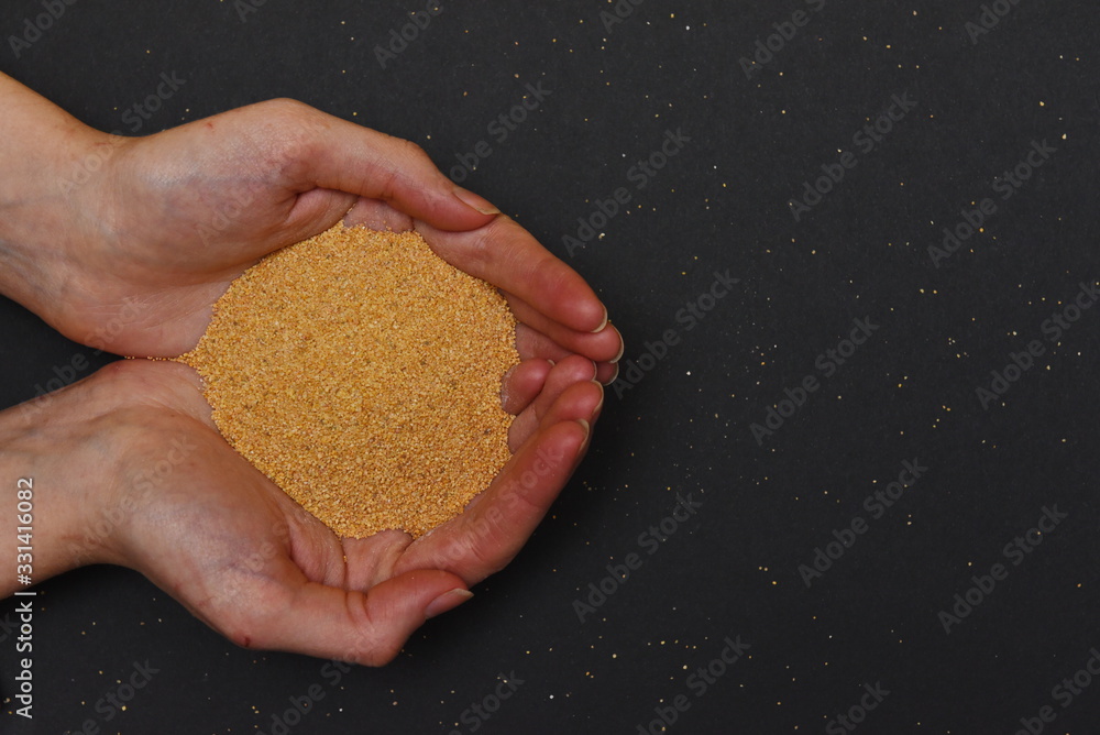 yellow decorative fine sand in two hands yellow decorative fine sand in two hands