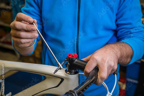 Tightening of a bicycle handlebar stem with the use of a small inbus wrench.