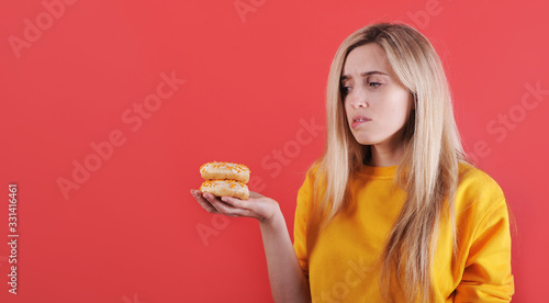 Portrait of smiling caucasian woman with donuts. 