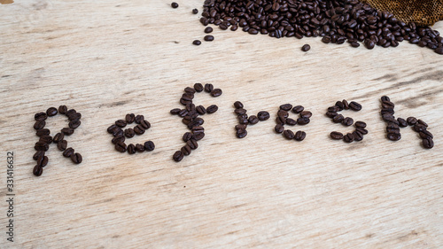 dark rose coffee bean, Black coffee cup on old wooden table top view.