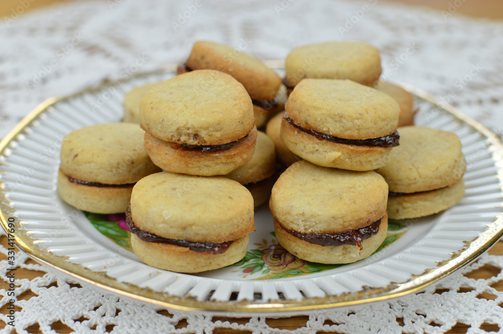 Traditional serbian vanilla cookies with jam, vanilice, on the vintage plate, close up Traditional serbian vanilla cookies with jam, vanilice, on the vintage plate, close up