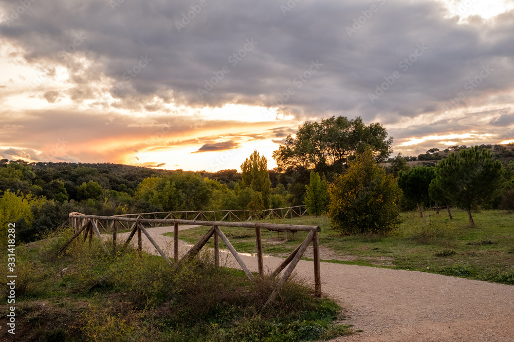 Obraz premium wooden handrail with sunset on background