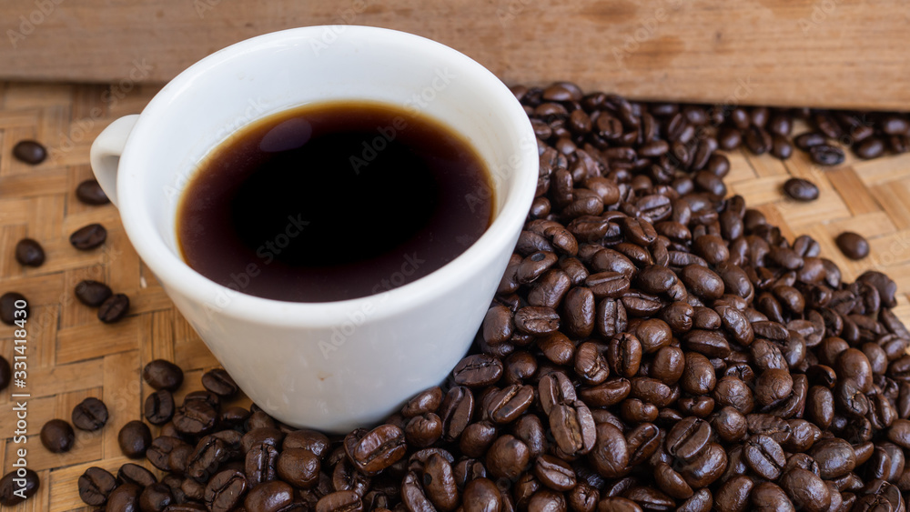 dark rose coffee bean, Black coffee cup on old wooden table top view. dark rose coffee bean, Black coffee cup on old wooden table top view.