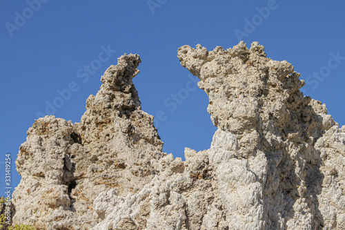 rough rock formation against a blue sky