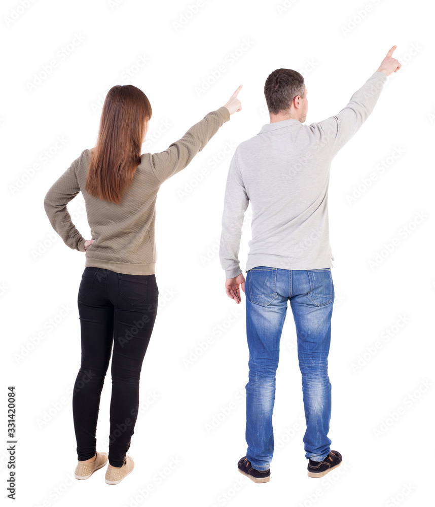 Back view of couple in sweater pointing. Back view of couple in sweater pointing.