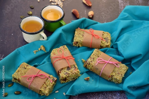 Matcha green tea breakfast bars made from oat, matcha powder, maple syrup, goji berry, pumpkin seed, sunflower seed, date, brazil nuts and sesame seeds. Served with hot tea 
