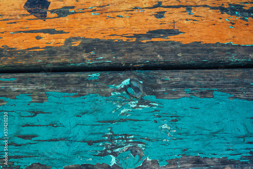 Old and weathered wooden texture with peeled blue and yellow paint. Abstract grunge background. 
