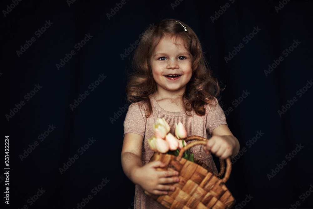 happy child with a basket of tulips in his hands happy child with a basket of tulips in his hands