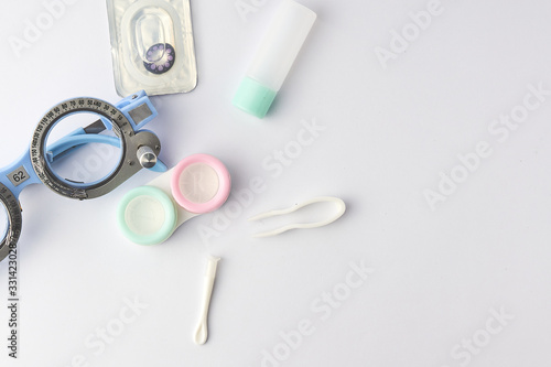 Contact lens with optometrist equipment tools on white background
