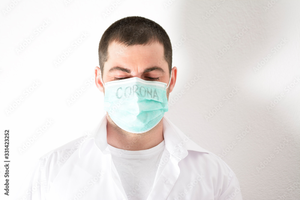 Man with mask to protect her from Corona virus. Corona virus pandemic. Corona written on mask. Doctor at the hospital. Man with mask to protect her from Corona virus. Corona virus pandemic. Corona written on mask. Doctor at the hospital.