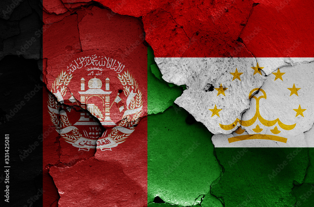 flags of Afghanistan and Tajikistan painted on cracked wall