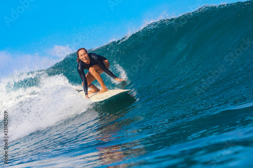 Female surfer on a blue wave