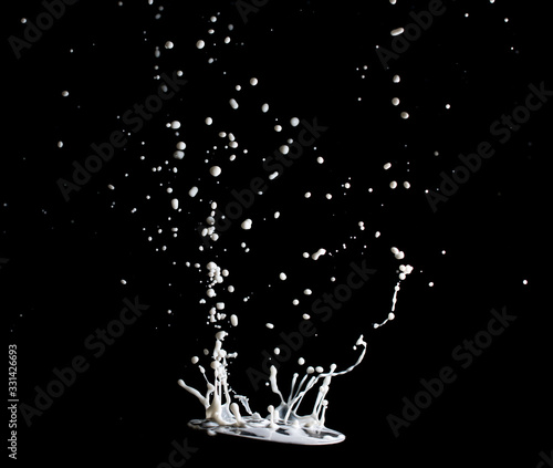 splashes and jets of milk on a black background