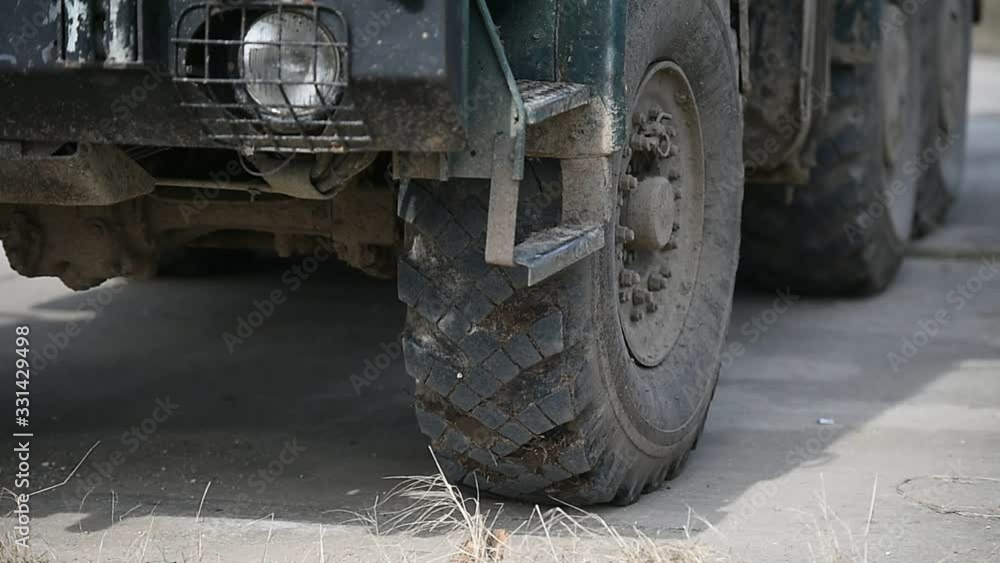 Army truck detail full of mud and sand during military exercise 