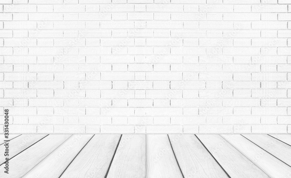 White empty wooden floors with brick wall background. Studio or office blank space.