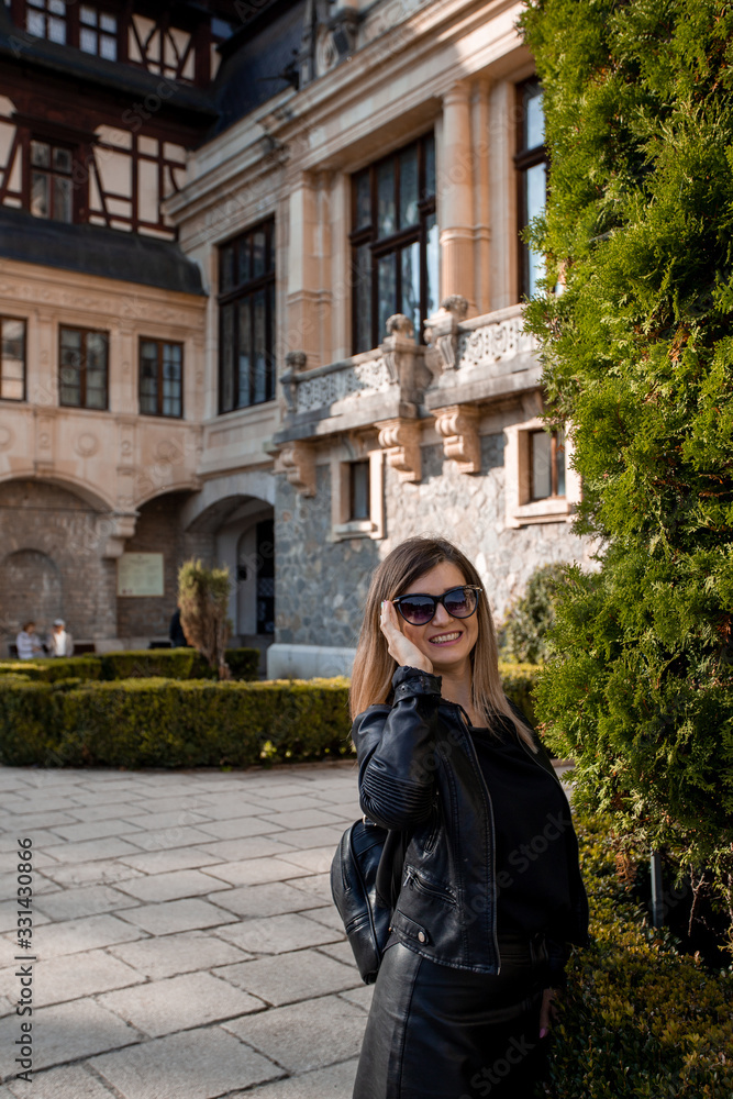 Beautiful young woman portrait with sunglasses. Old Castel in the background