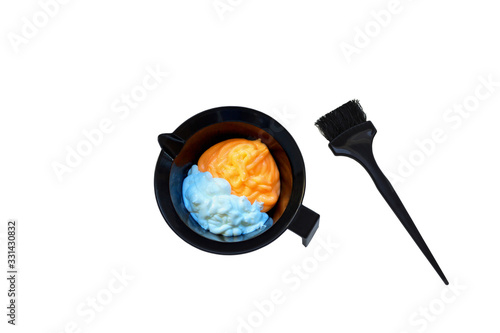 Mixing hair dye in a special plastic bowl. Concept is hair coloring. Isolated on white. photo