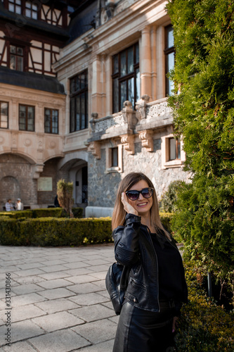 Beautiful young woman portrait with sunglasses. Old Castel in the background
