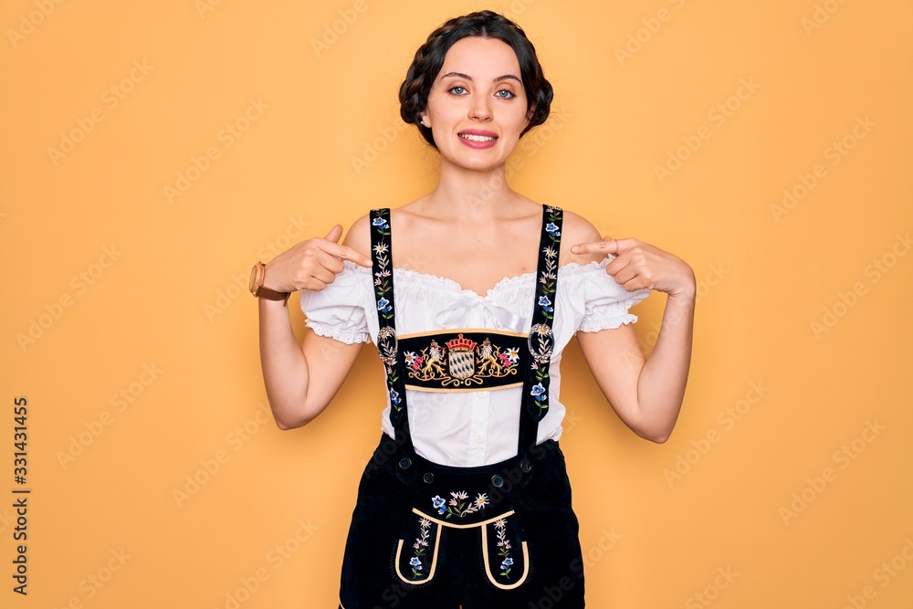 Young beautiful german woman with blue eyes wearing traditional octoberfest dress looking confident with smile on face, pointing oneself with fingers proud and happy. Young beautiful german woman with blue eyes wearing traditional octoberfest dress looking confident with smile on face, pointing oneself with fingers proud and happy.
