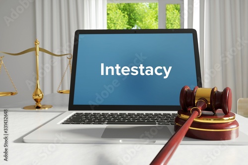 Intestacy – Law, Judgment, Web. Laptop in the office with term on the screen. Hammer, Libra, Lawyer. photo