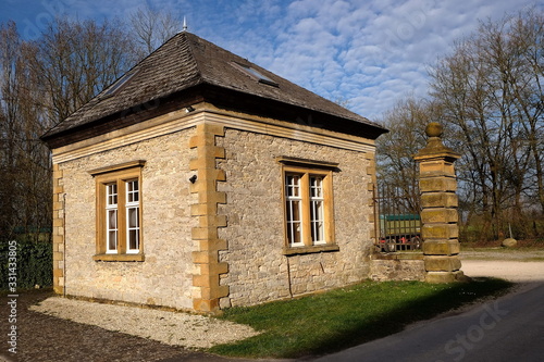 Restauriertes Pförtnerhaus aus Sandstein und Bruchstein in Beige und Naturfarben im Sonnenschein am Gut Barkhausen in Asemissen bei Leopoldshöhe und Bielefeld am Teutoburger Wald in Ostwestfalen-Lippe photo