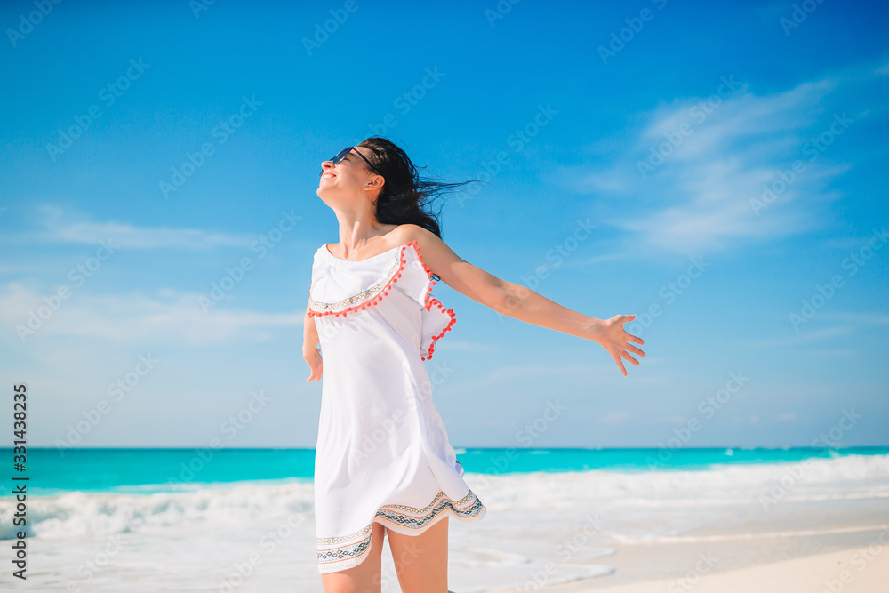 Young woman enjoying the sun sunbathing by perfect turquoise ocean Young woman enjoying the sun sunbathing by perfect turquoise ocean