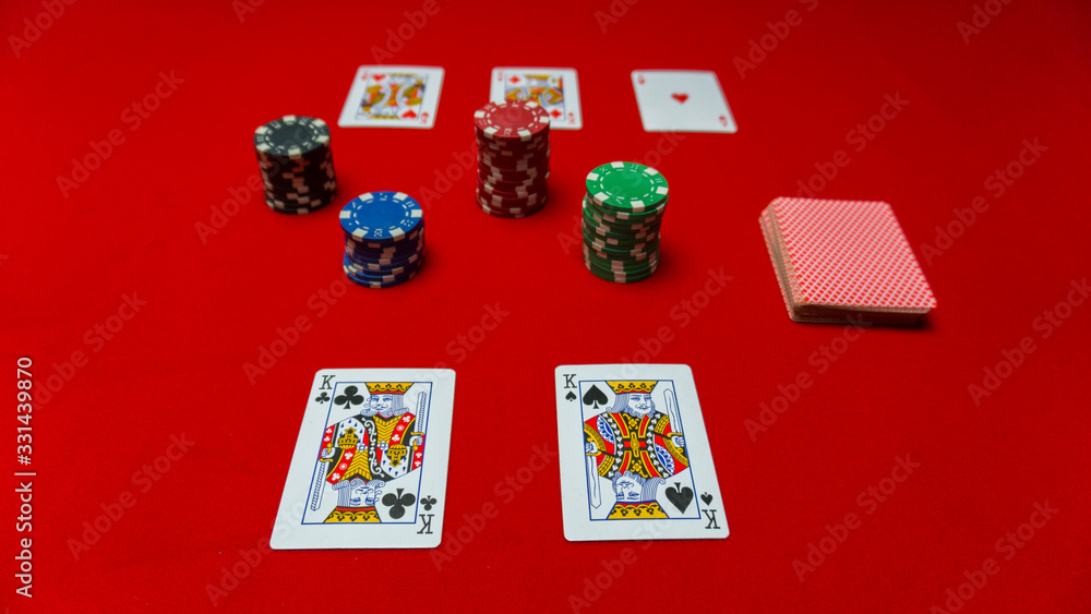 poker chips, dollars, cards on a red gaming table poker chips, dollars, cards on a red gaming table