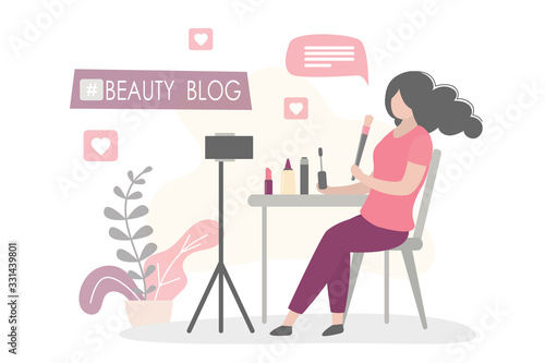 Female beauty blogger making review for cosmetics and recording video for her blog.