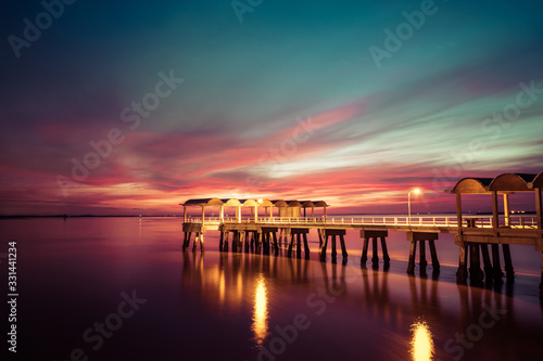 A beautiful ocean dramatic sunset and fishing pier at Jekyll Island in coastal Georgia, USA. © Nickolay Khoroshkov