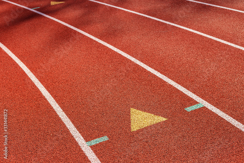 Red color running track in school stadium