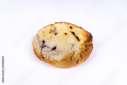 A cookie cheesecake with blueberries on white background with copy space - angled view