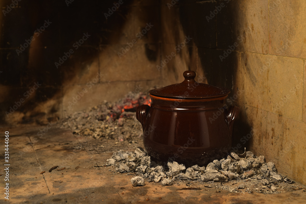 Meat cooked in the pignata on the fire Meat cooked in the pignata on the fire