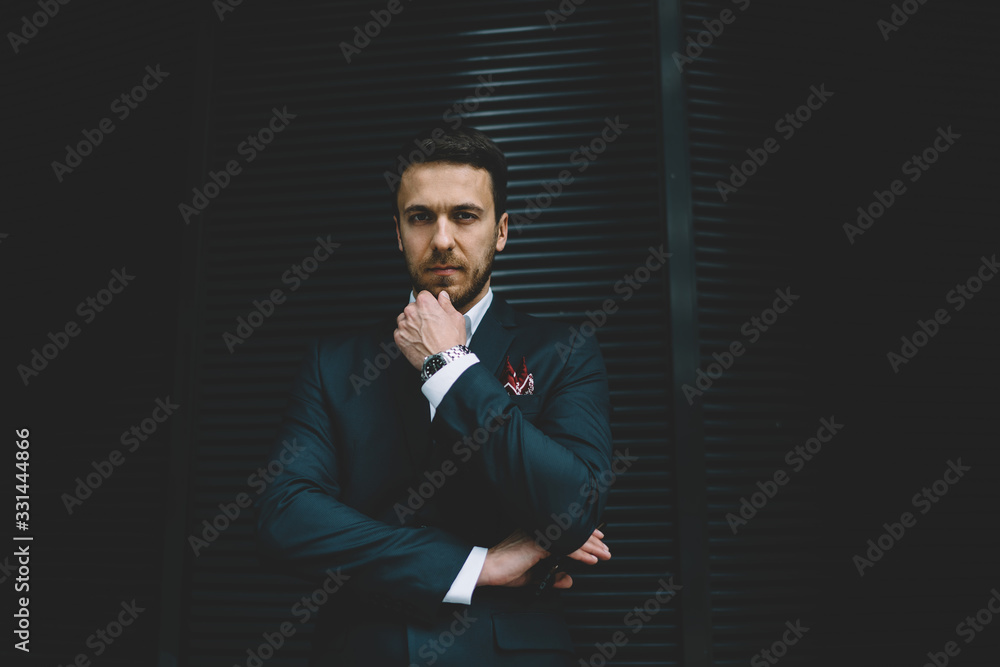 Thoughtful businessman looking for solution and standing at wall Thoughtful businessman looking for solution and standing at wall