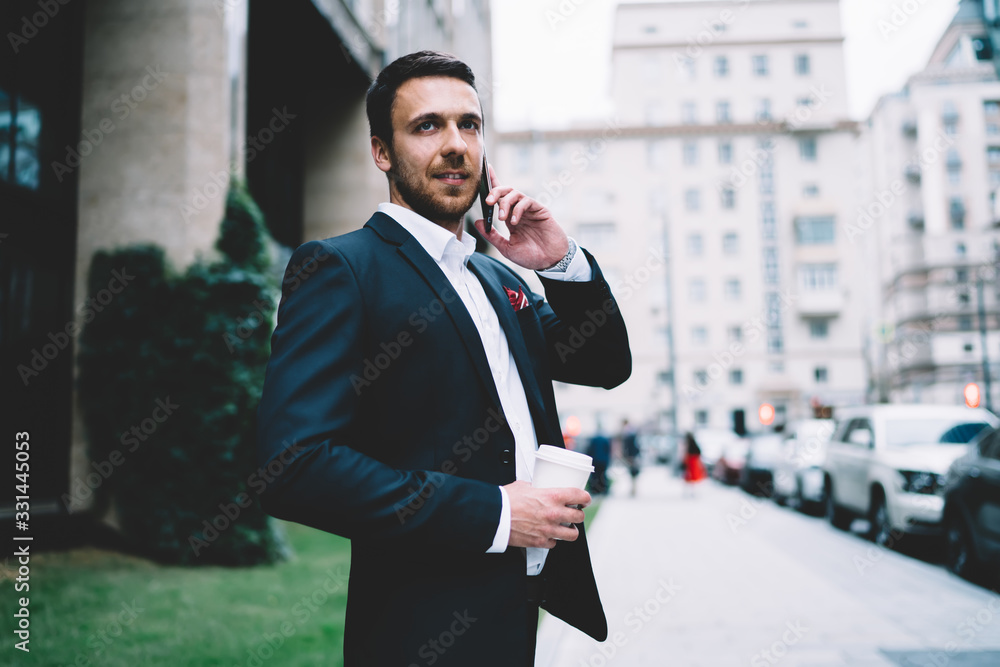 Male office employee in formal wear calling on smartphone at city street Male office employee in formal wear calling on smartphone at city street