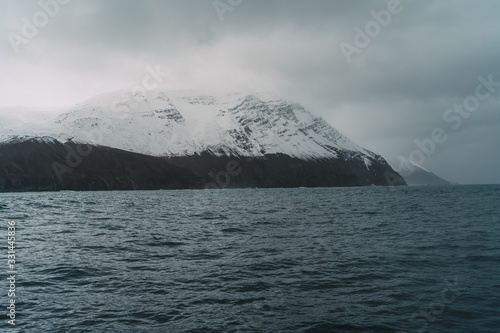 Ocean and snowy mountains in Iceland in northern Fjords