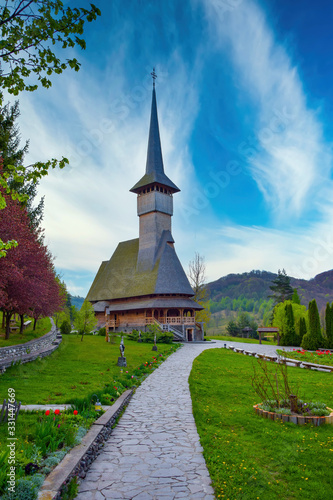 Footpath to traditional Maramures neo gothic wooden church in Barsana monastery, Romania